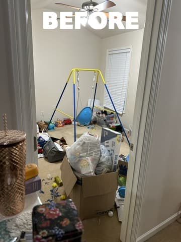 Apartment room packed with furniture and household items before cleanout